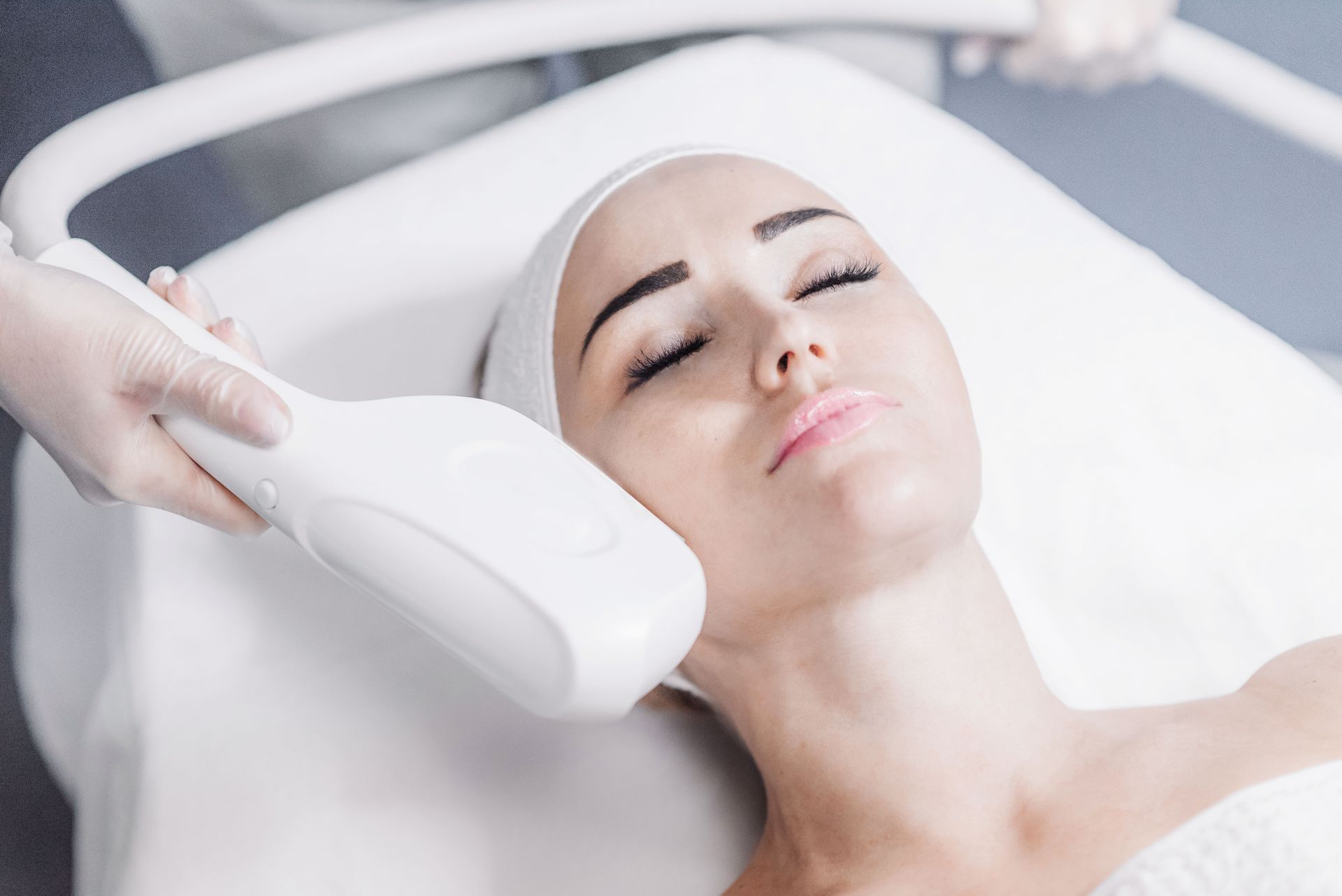 Woman undergoing facial laser treatment.