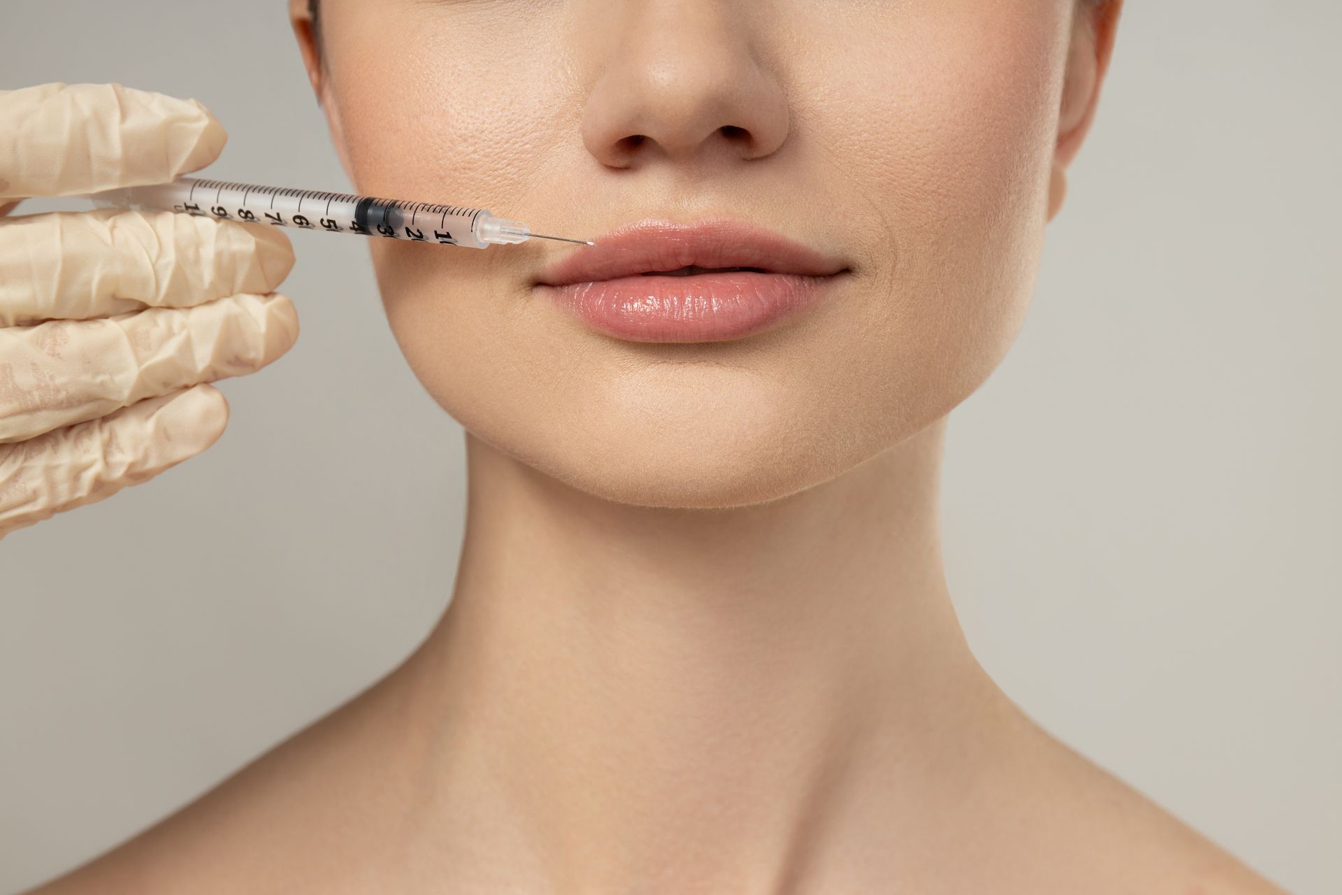 Close-up of a beauty injection being prepared for lips.