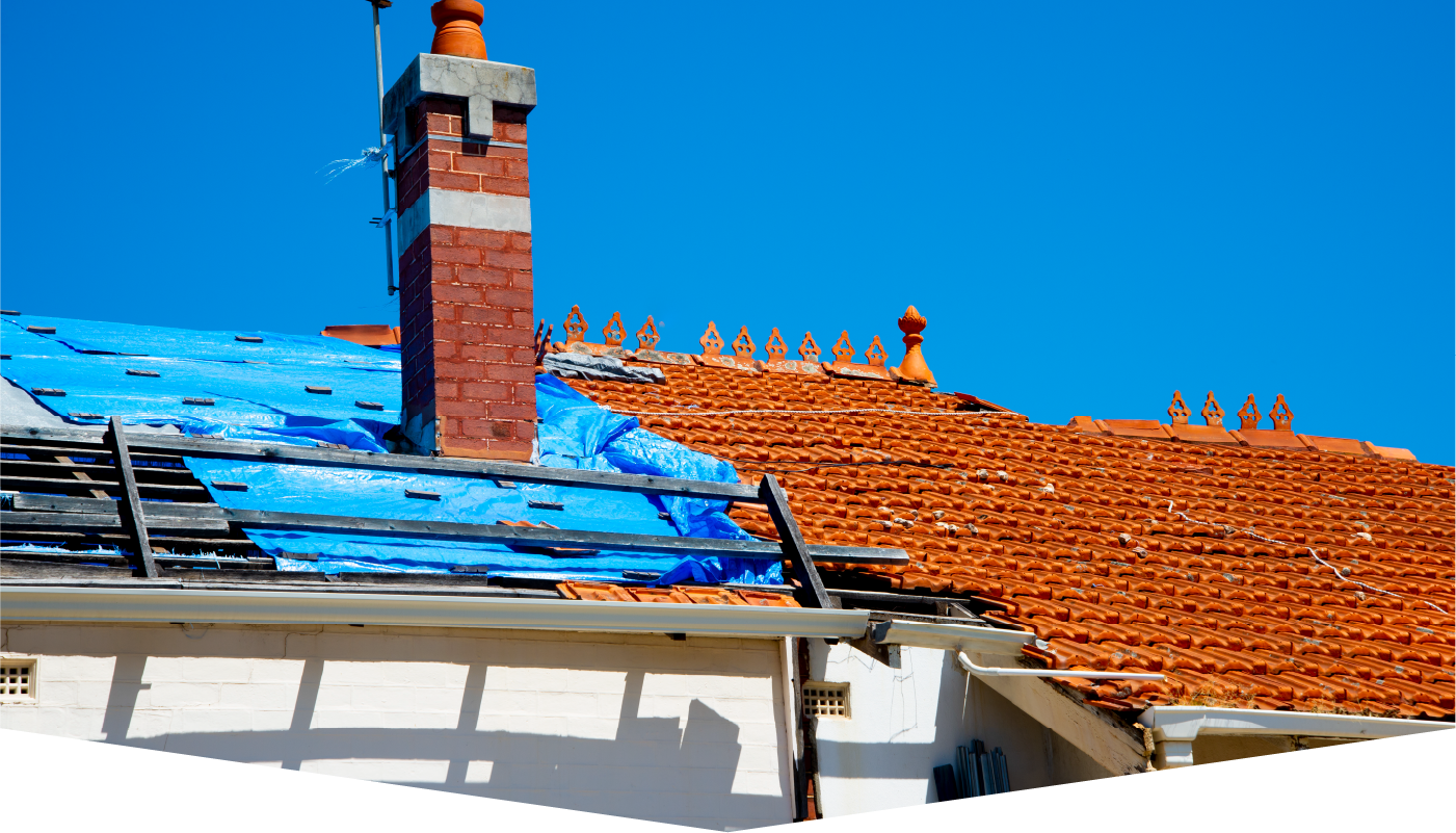 A roof with a chimney and a blue tarp on it.
