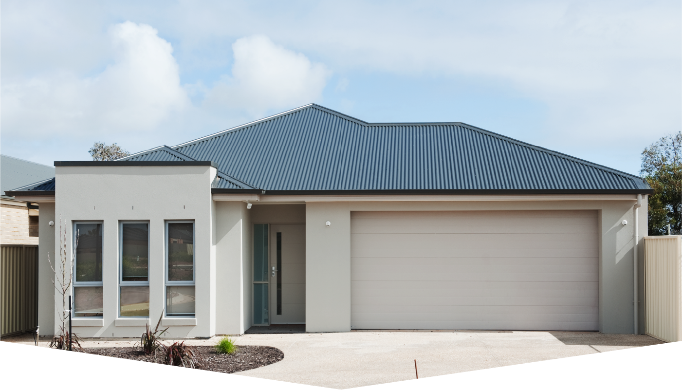 A white house with a blue roof and a white garage door
