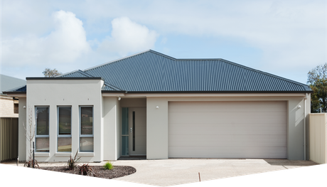 A white house with a blue roof and a white garage door