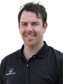 A man wearing a black shirt with the word ace on it