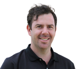 A man in a black shirt is smiling for the camera