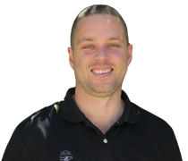 A man wearing a black polo shirt is smiling for the camera