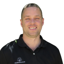 A man wearing a black polo shirt with a logo on it