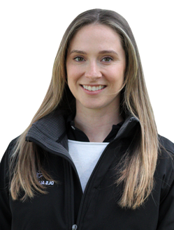 A woman wearing a black jacket and a white shirt is smiling.
