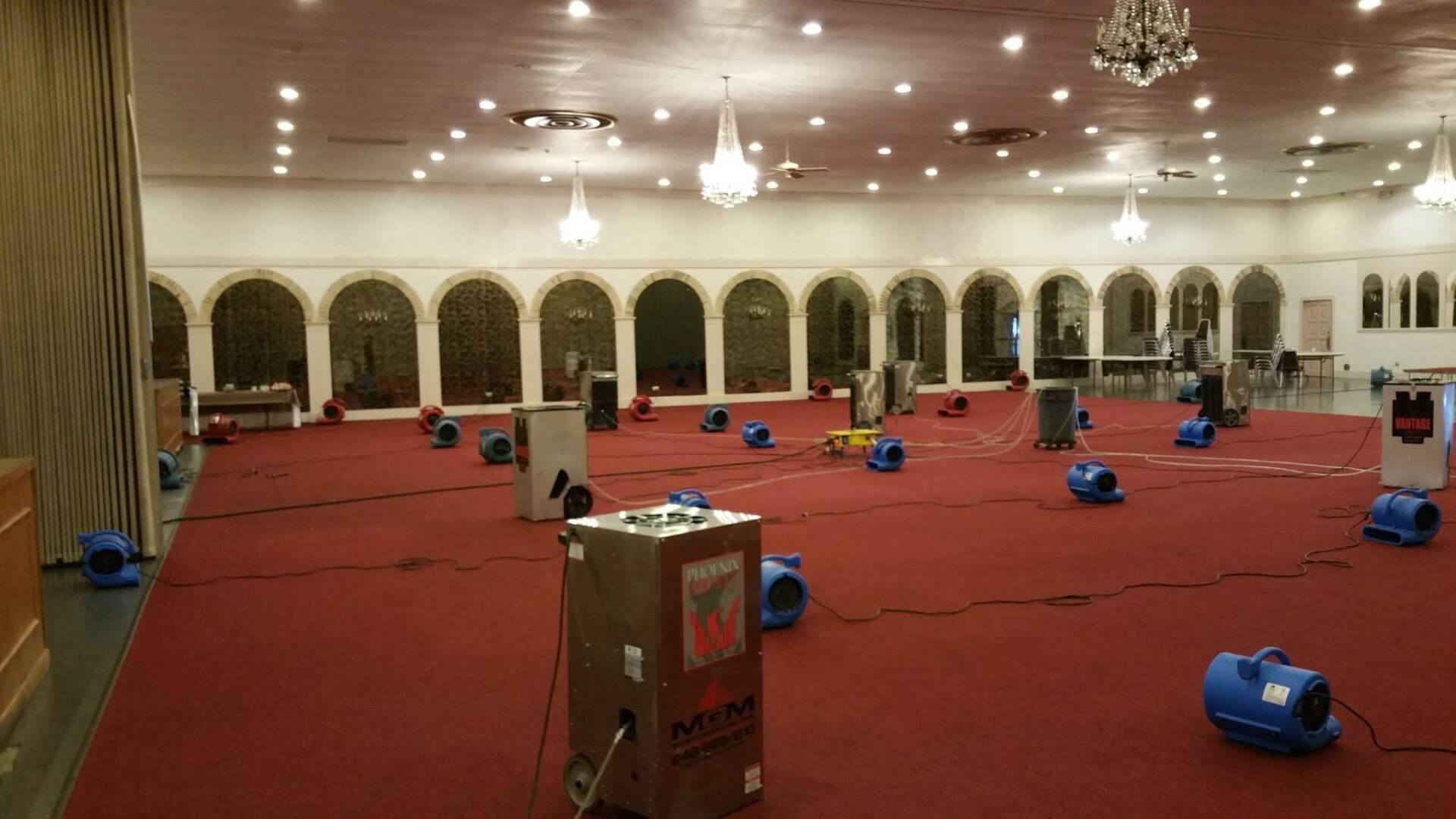 A large room with a lot of fans on the floor.