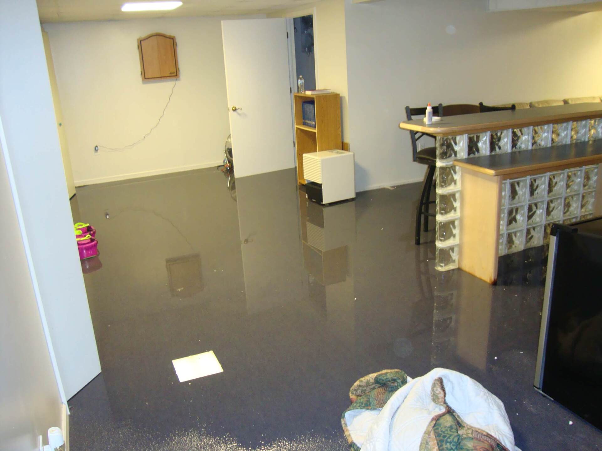 A flooded basement with a bar and a couch