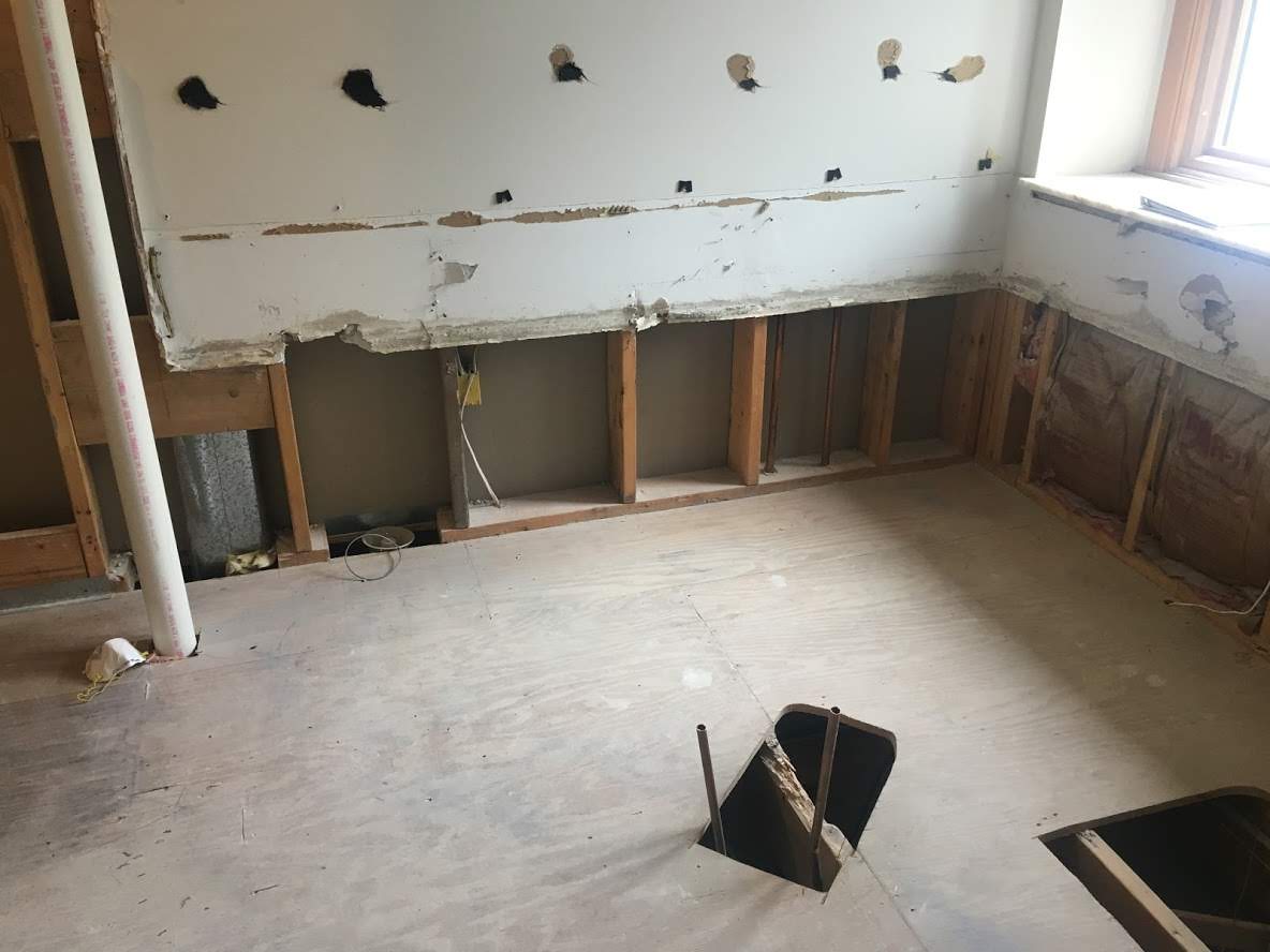 A room with a hole in the floor and a window.