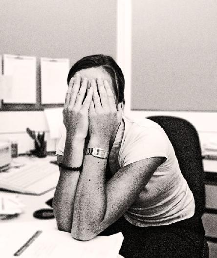 Women in office hiding her face