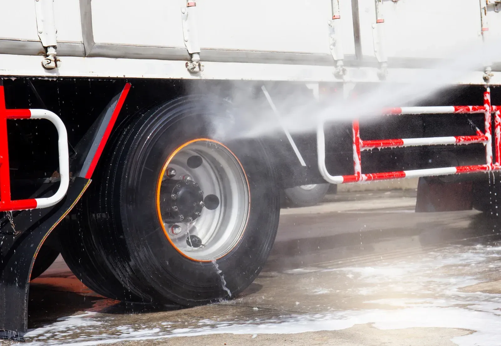 Truck tires being sprayed with water.