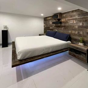 a bedroom with a floating bed and a wooden wall .