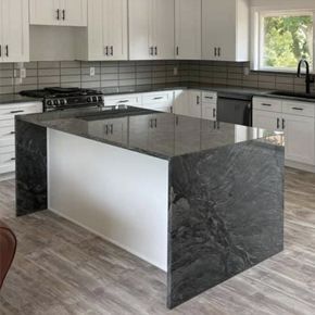 there is a large island in the middle of the kitchen .