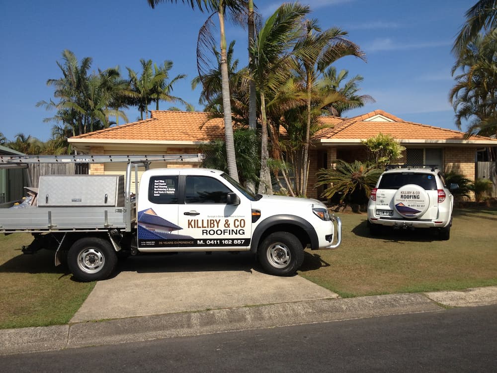 A White Truck is Parked in Front of a House — Killiby & Co Roofing Pty Ltd In Tweed, NSW