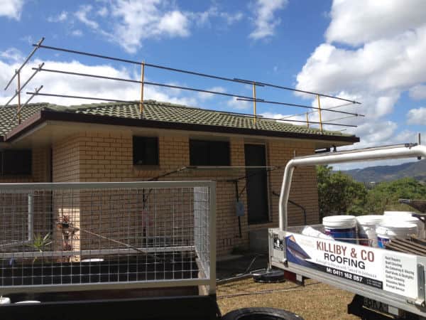 A Roofing Truck is Parked in Front of a House — Killiby & Co Roofing Pty Ltd In Tweed, NSW