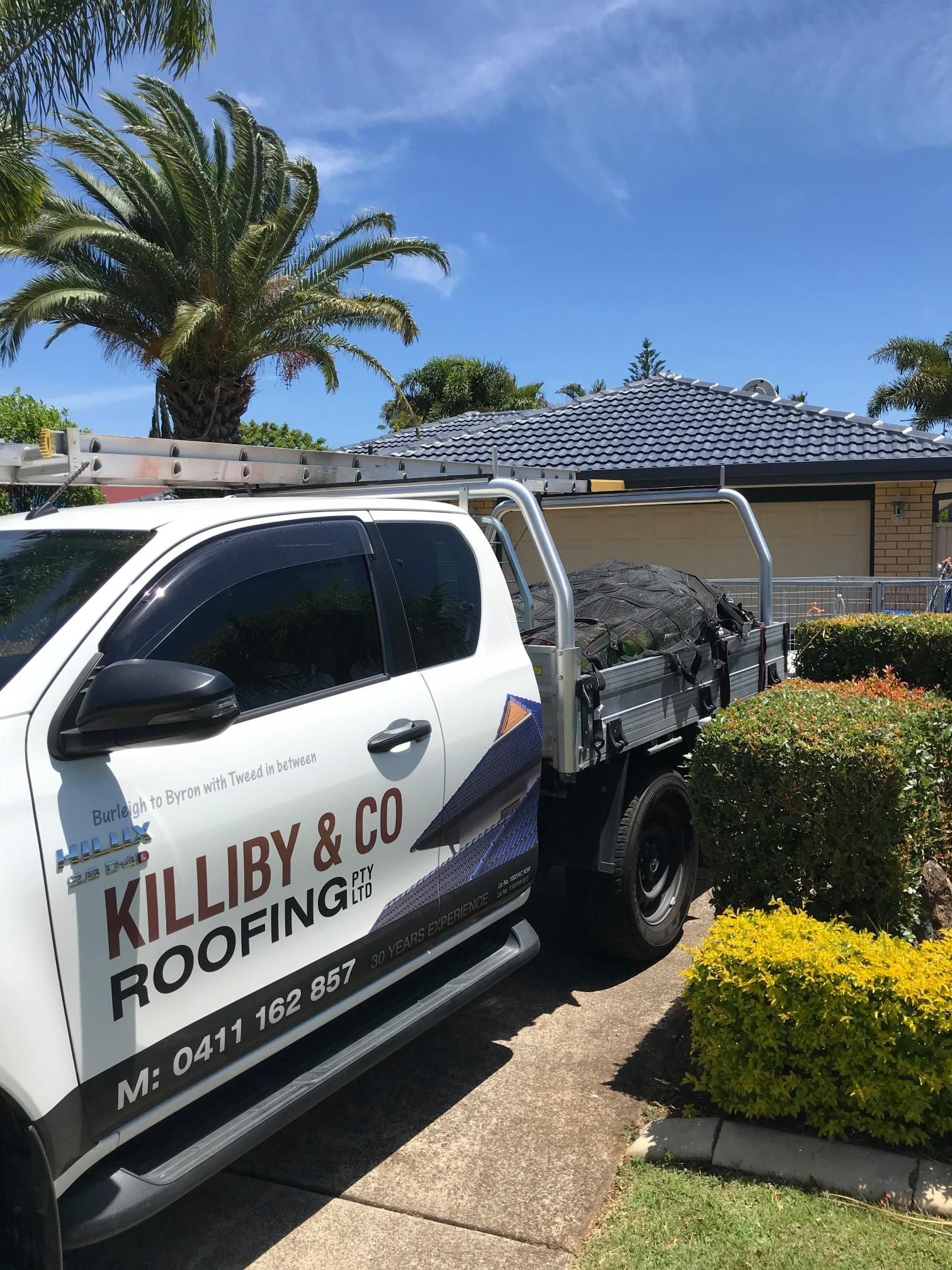 White Work Truck Parked Near a House — Killiby & Co Roofing Pty Ltd in Byron Bay, NSW