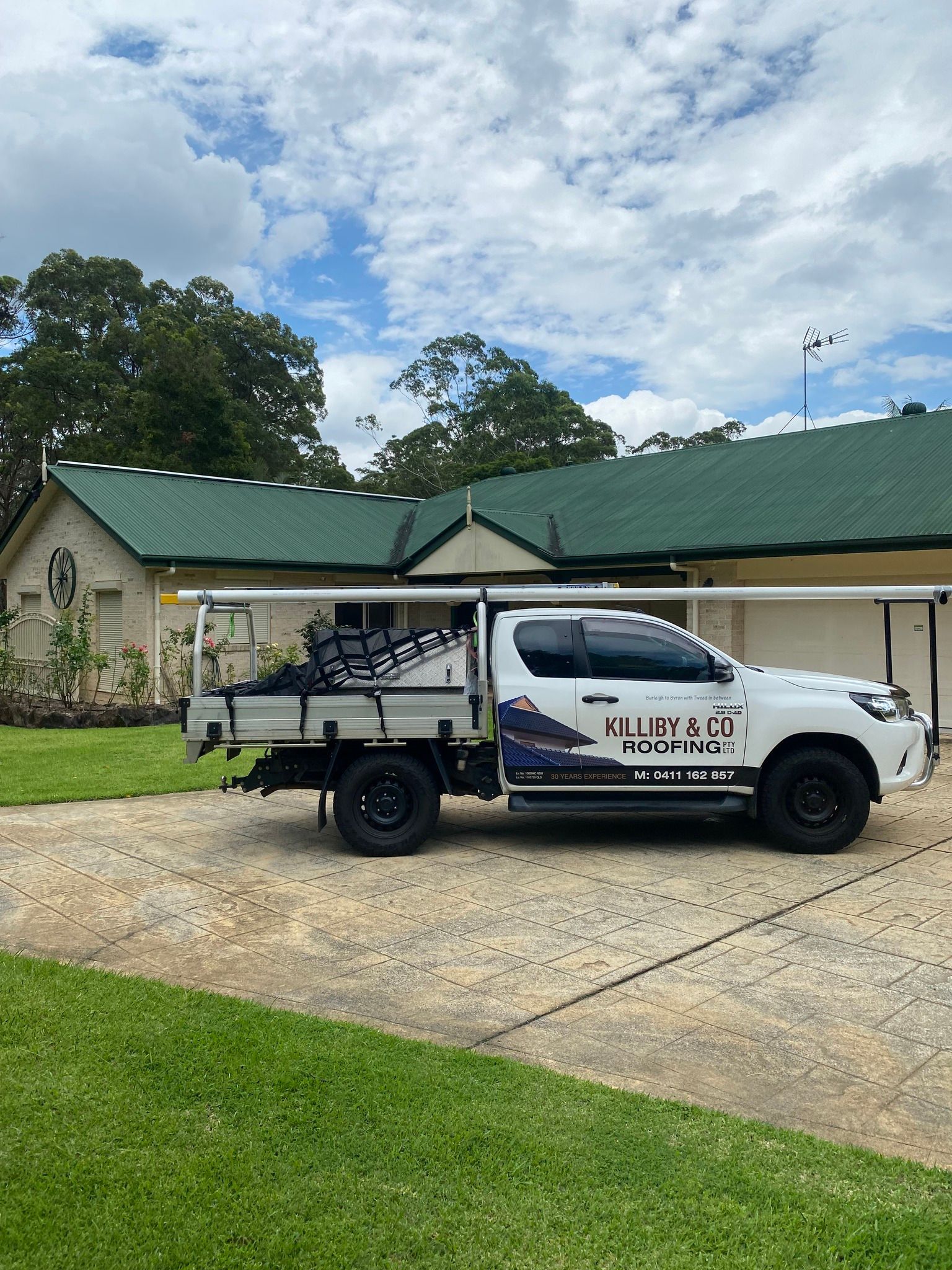 White Work Truck Parked on a Driveway in Front of a House — Killiby & Co Roofing Pty Ltd in Ocean Shores, NSW