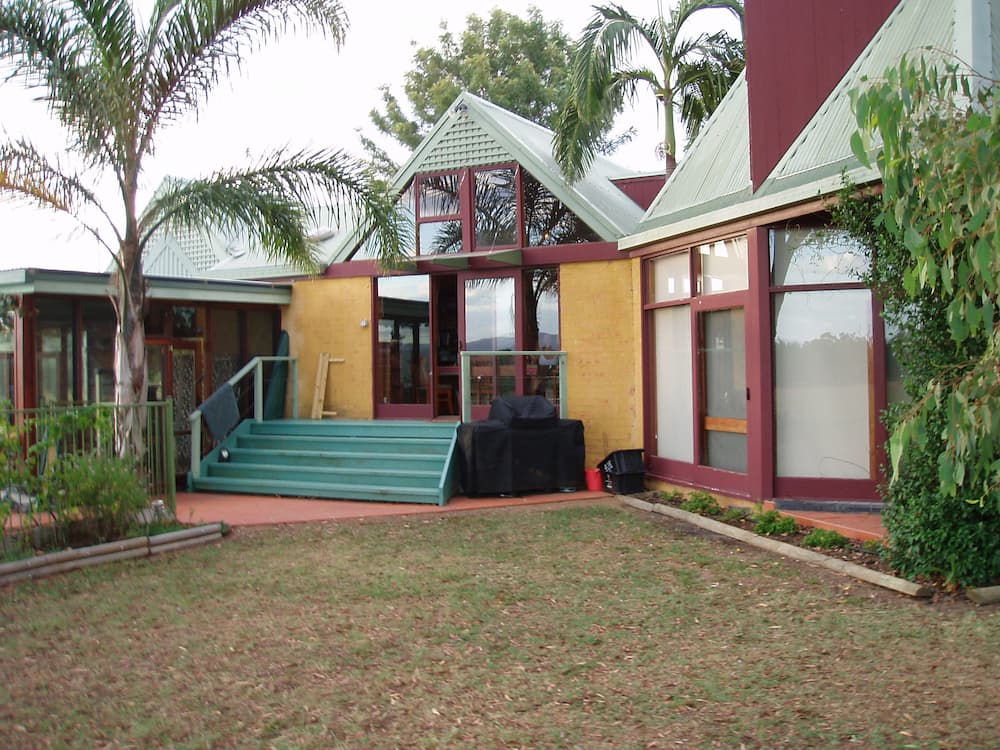 A Large House With a Lot of Windows and Stairs — Killiby & Co Roofing Pty Ltd In Tweed, NSW