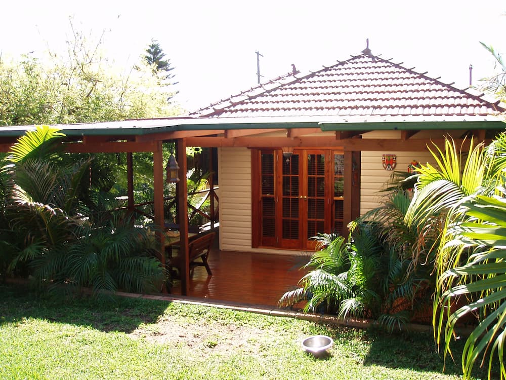 A Small House With a Covered Porch and a Patio — Killiby & Co Roofing Pty Ltd In Tweed, NSW