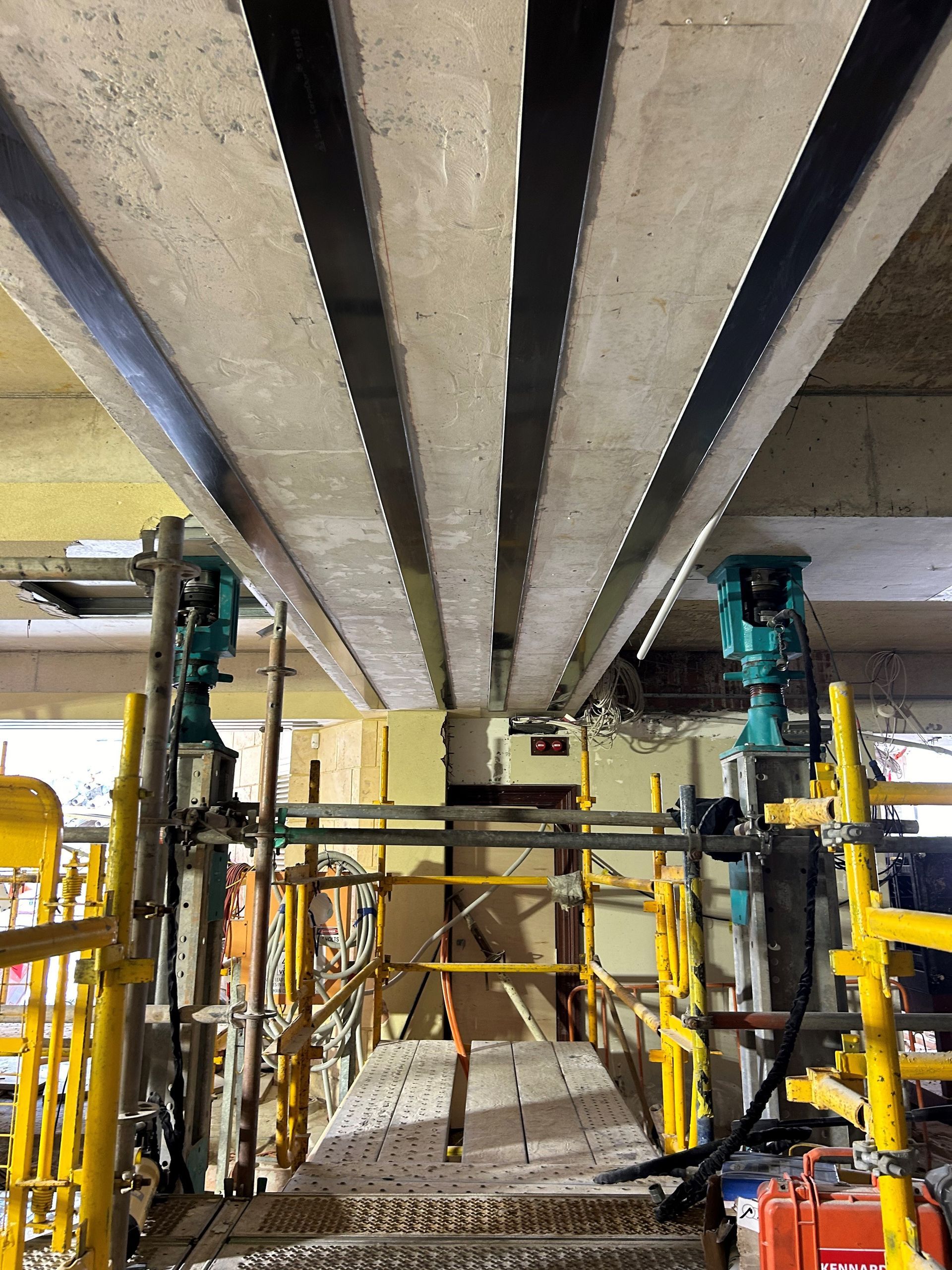 A construction site with a lot of scaffolding and pipes.