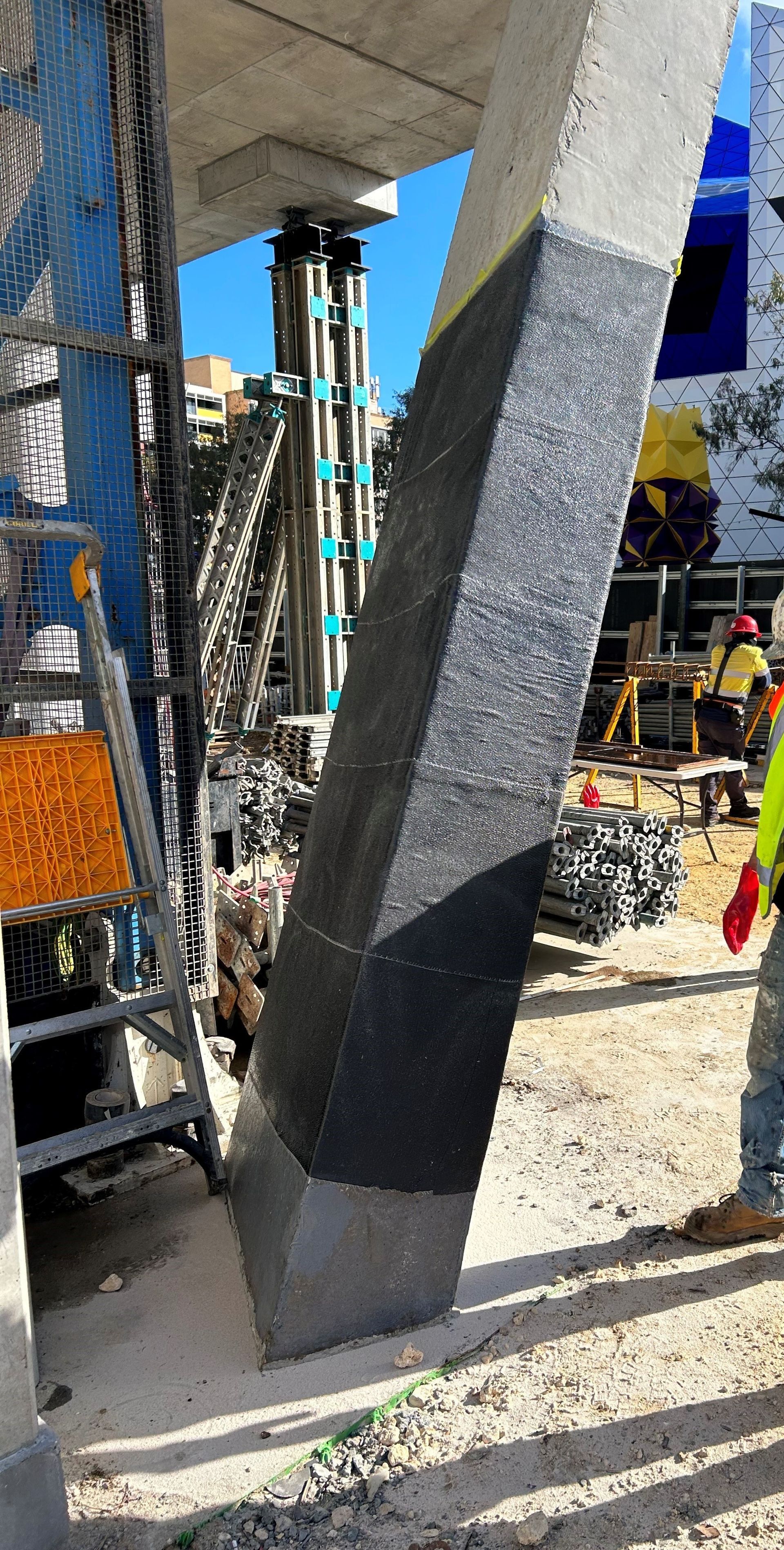 A construction worker is working on a concrete floor.