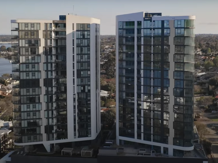 An artist 's impression of a large building next to a body of water.