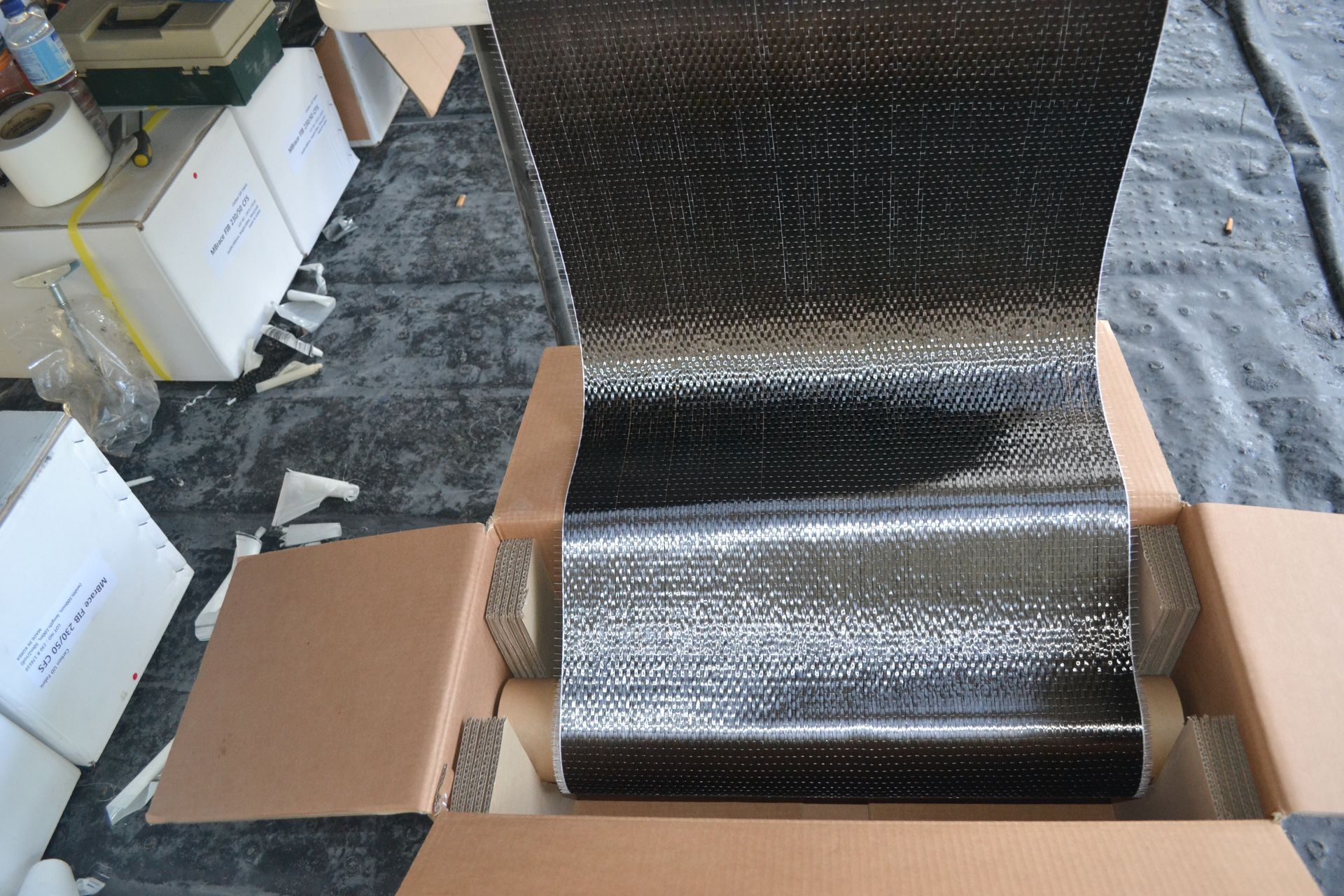 A close up of a metal grate on a concrete floor.