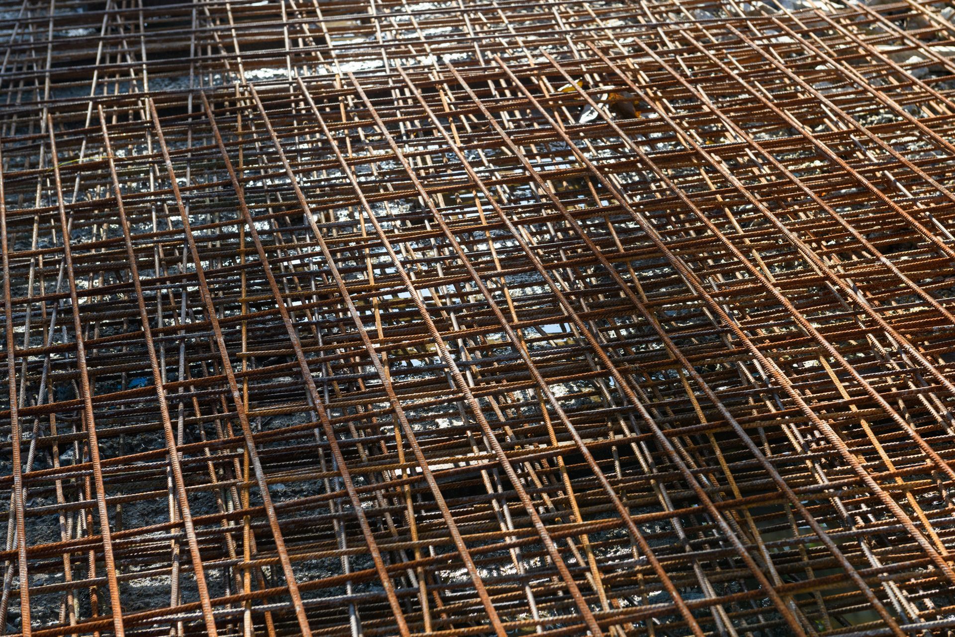 Rusty steel rebar grid close-up used for concrete reinforcement in construction site work