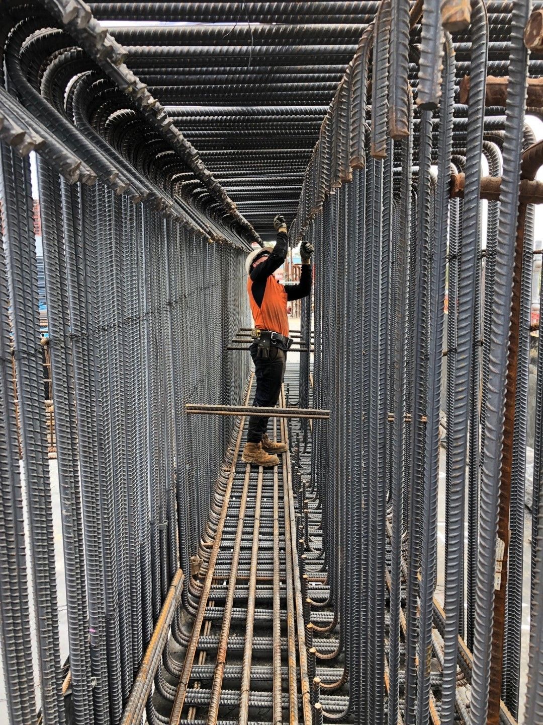 A man is working on a bridge under construction.