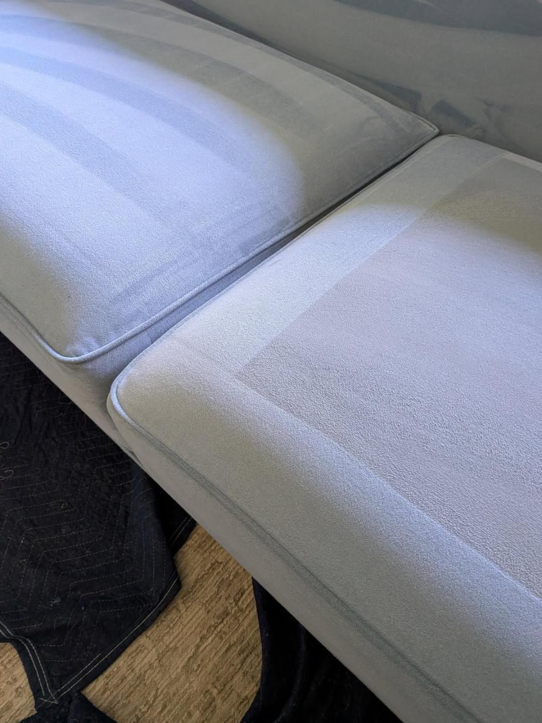 Light blue couch cushions, one partially cleaned with visible cleaning marks.