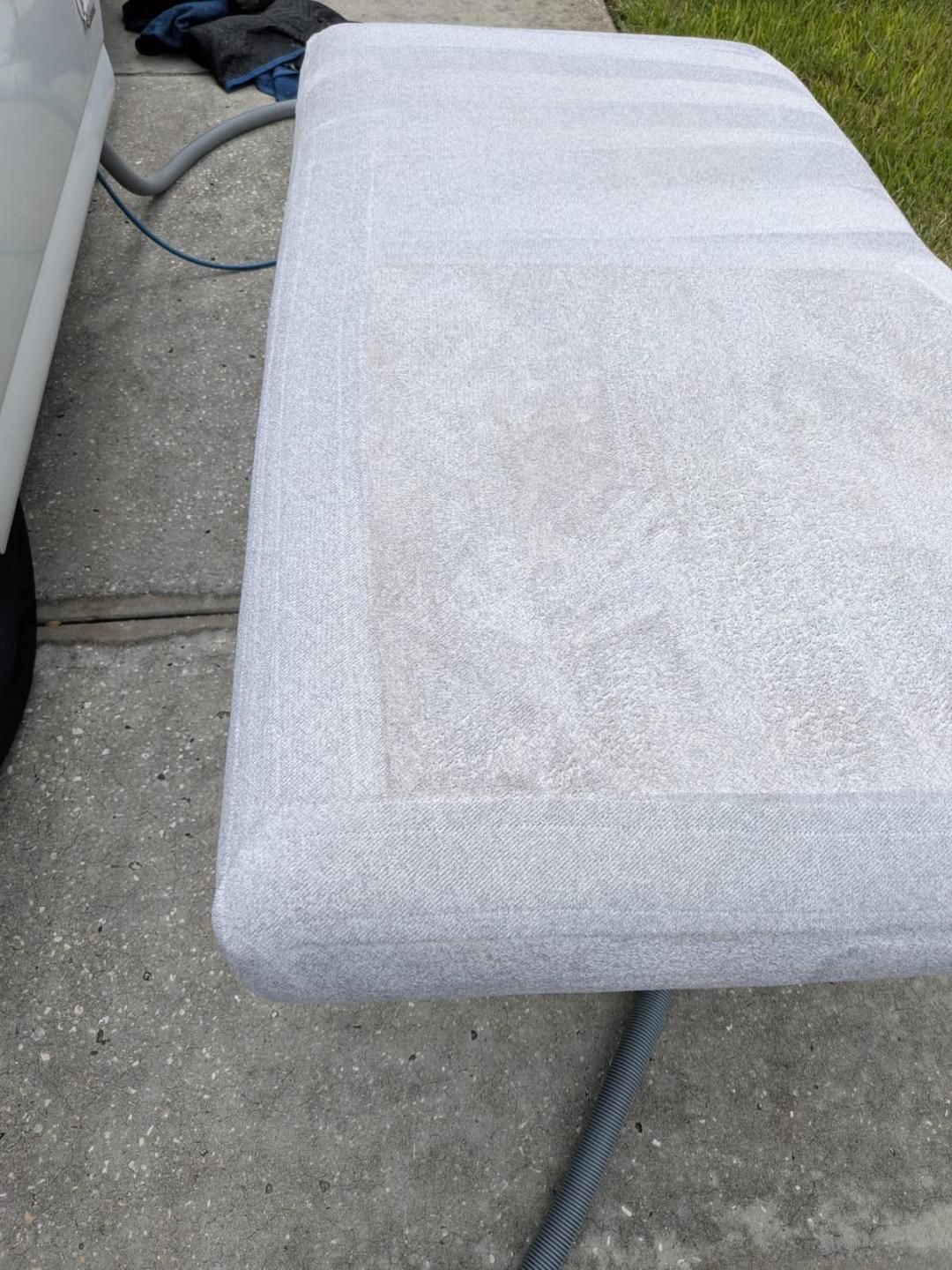 Light gray, stone-looking cushion outside. Shows the top and curved corner.