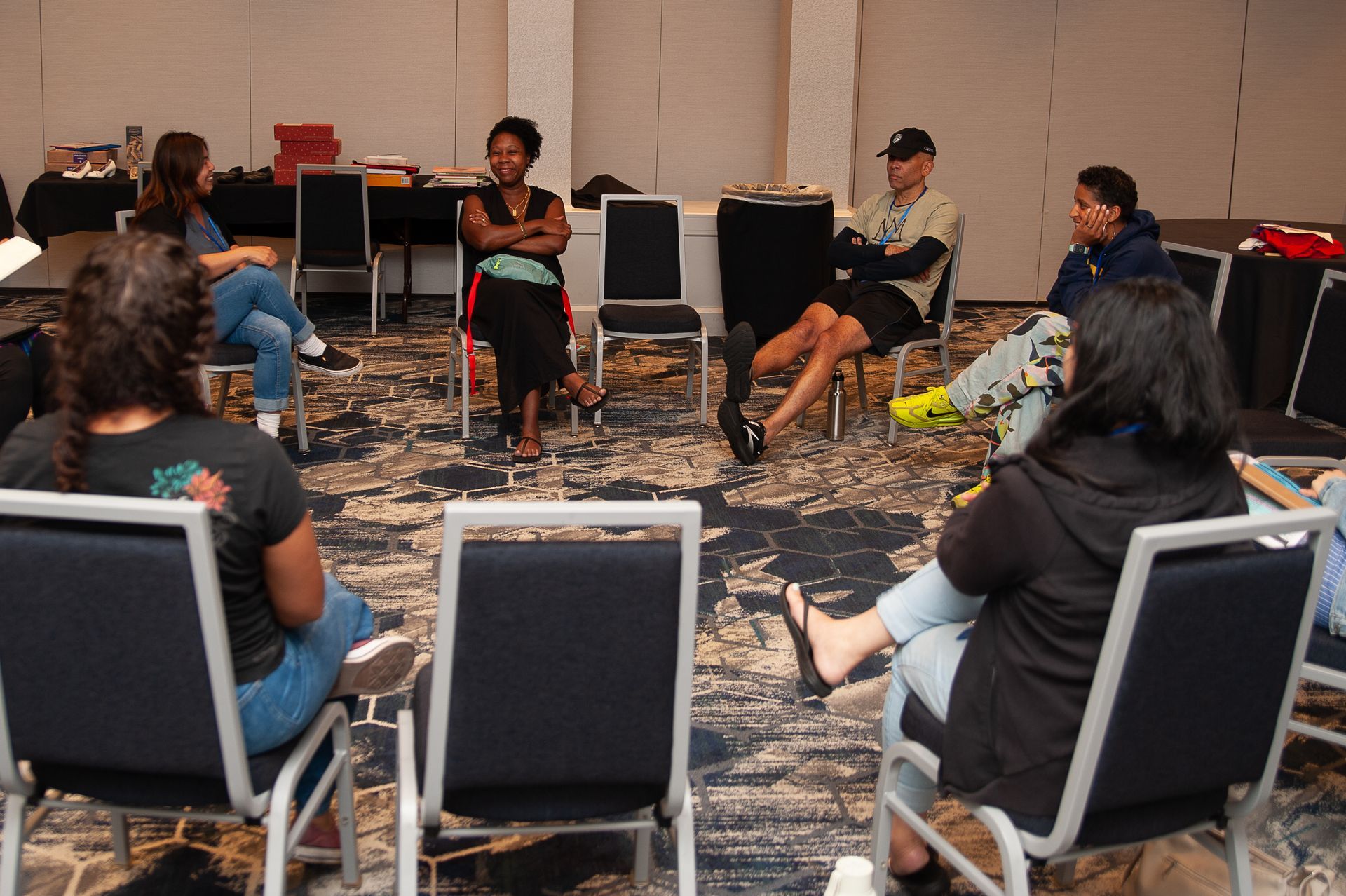 A group of people are sitting in chairs in a circle.