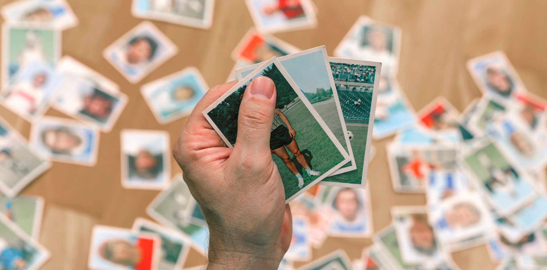 A person is holding a stack of playing cards in their hand.