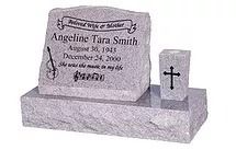 Gray granite headstone; inscribed with name, dates, quote, and a violin. Small cross-shaped memorial next to it.