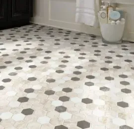 Bathroom floor tiled with a repeating geometric pattern of white, beige, and dark gray hexagonal tiles.