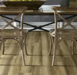 Two wooden cross-back chairs with woven seats positioned at a rustic dining table on a light wood-look floor.