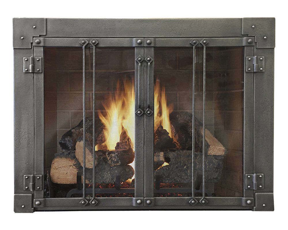 Fireplace with burning logs behind a hinged metal screen.