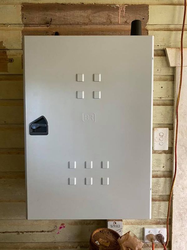 A White Box is Hanging on a Wooden Wall — Mick Sawtell Electrical Pty Ltd in South Lismore, NSW