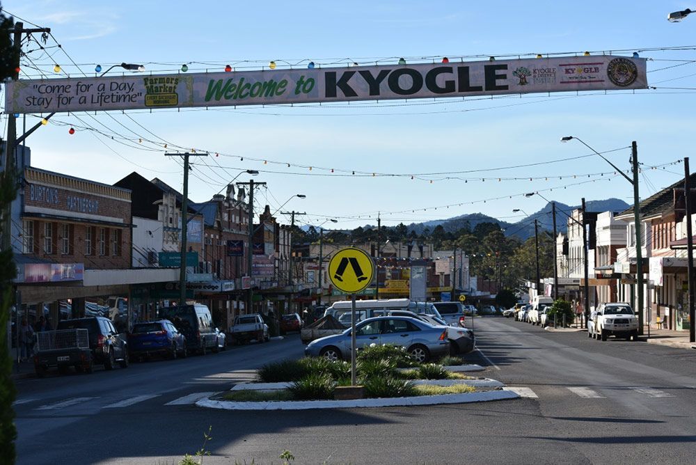 A City Street With a Sign That Says Welcome to Kyogle — Mick Sawtell Electrical Pty Ltd in Kyogle, NSW