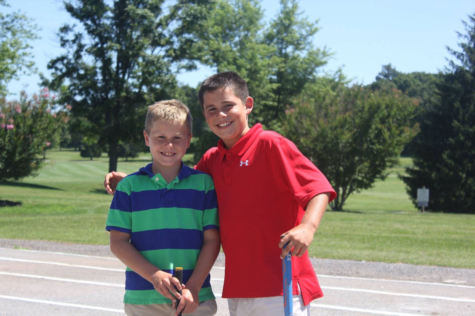 A group of people are walking on a golf course