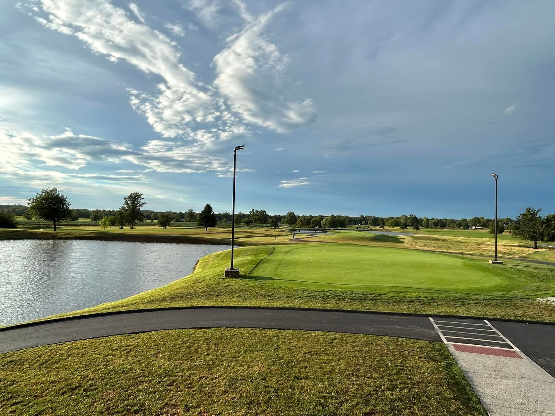 A view of a golf course with a lake in the background