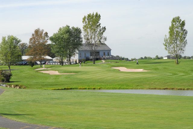 A golf course with a house in the background