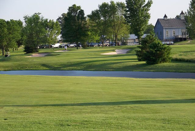 A golf course with a house in the background