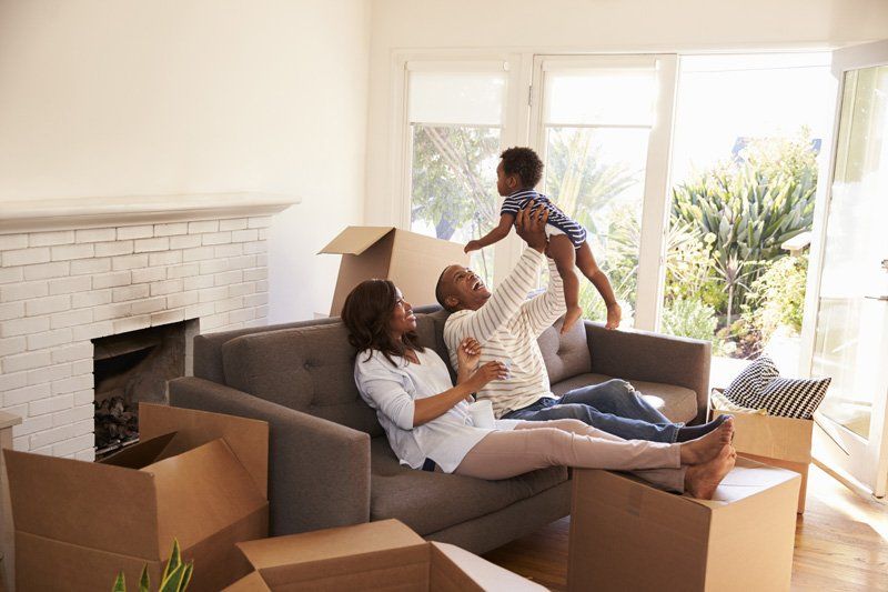 Parents take a break on the sofa with their son on move in day