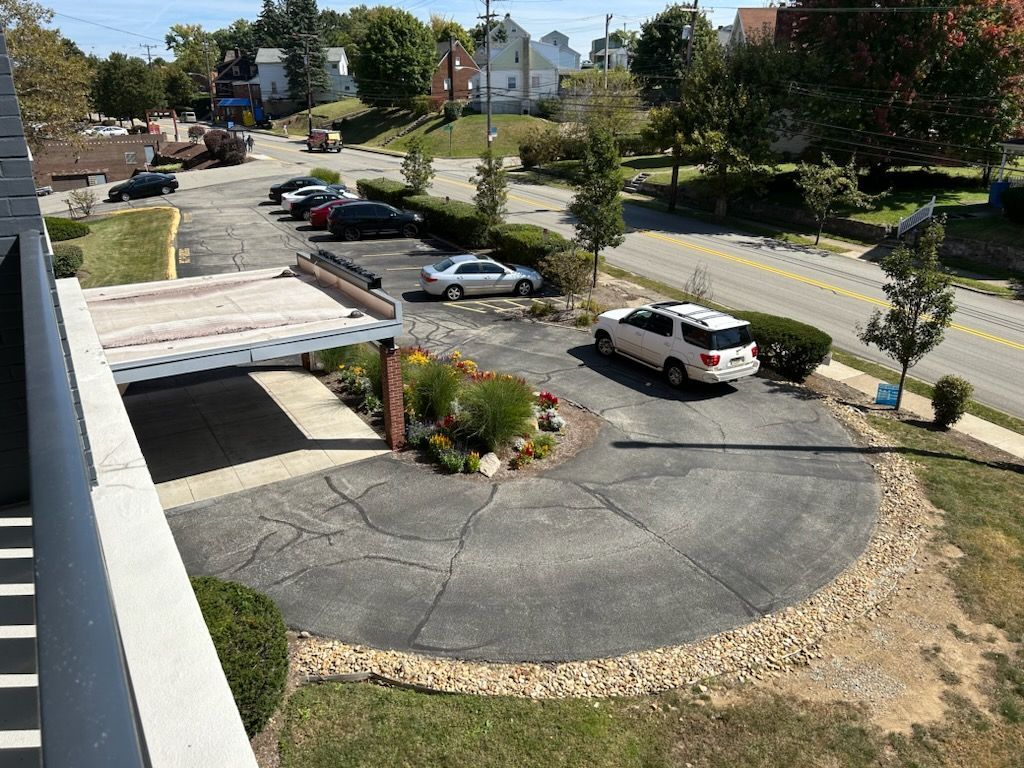 An aerial view of a parking lot with cars parked in it