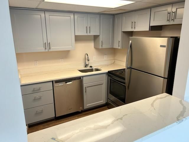 A kitchen with stainless steel appliances and white cabinets