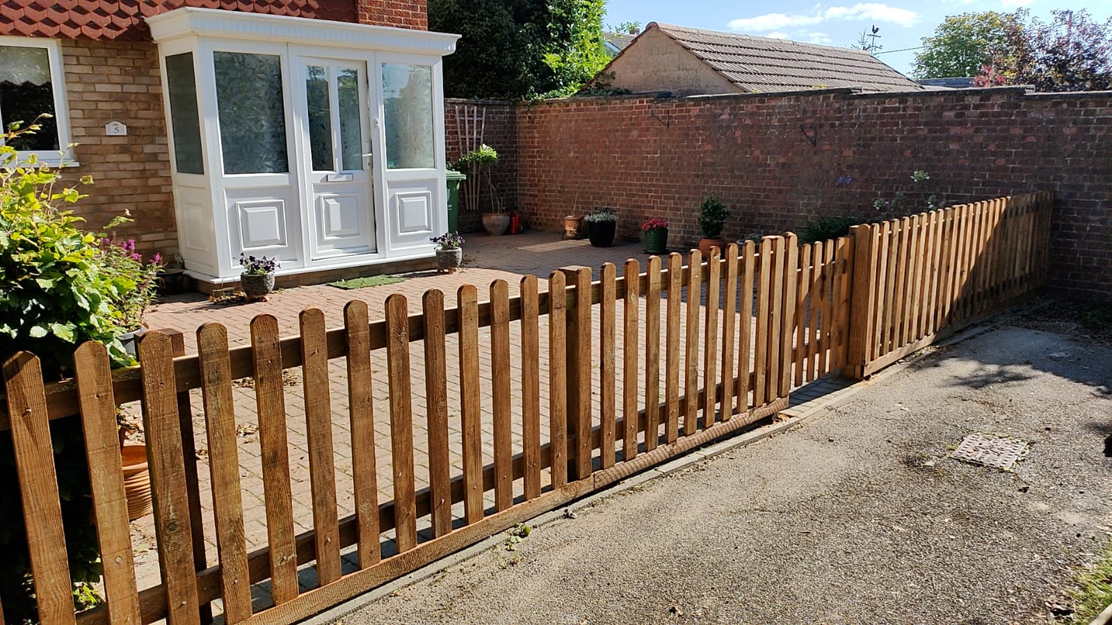 3 ft high open slatted picket fence giving a very open feel and view.