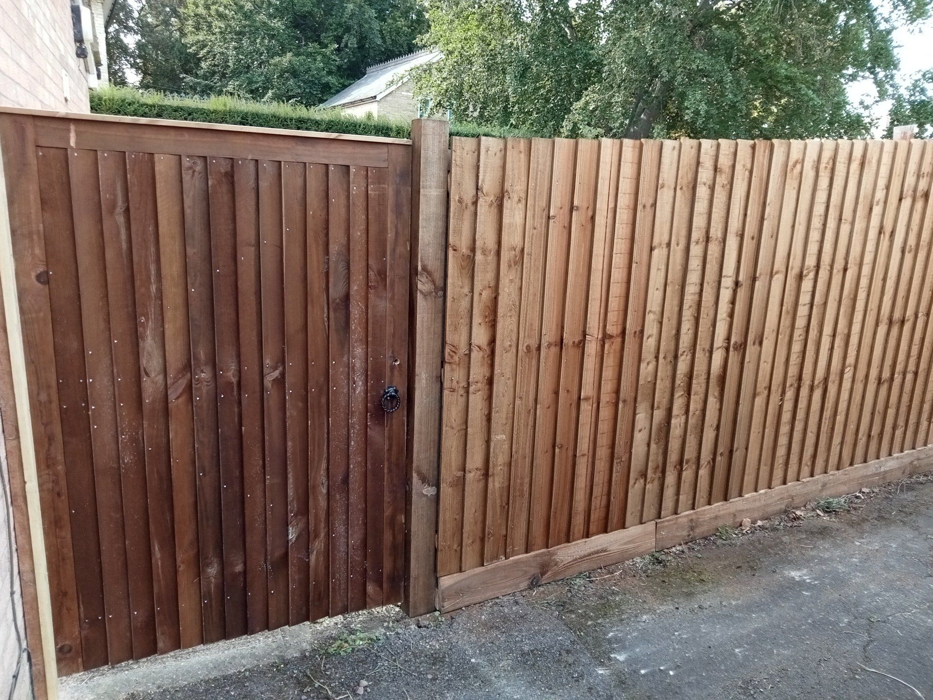 A wider than usual bespoke  6 ft single gate set into a feather edge fence, set at the same height as the fence to blend in.