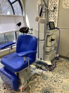 A blue chair in a room next to a window