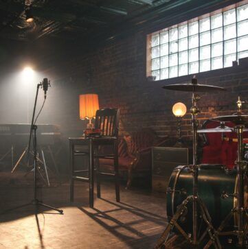 a drum set is sitting on a stage in a dark room .